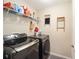 Laundry room with washer, dryer, and extra shelving at 13700 Sw 71St Ln, Ocala, FL 34481