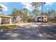 View of the pool and screened enclosure with detached shop in the background at 13700 Sw 71St Ln, Ocala, FL 34481