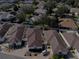 Aerial view of a community of tan houses with brown roofs at 17074 Se 75Th Wickson Ct, The Villages, FL 32162