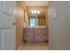 Bathroom with light wood vanity and shower at 17074 Se 75Th Wickson Ct, The Villages, FL 32162