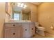 Bathroom with wood vanity and a toilet at 17074 Se 75Th Wickson Ct, The Villages, FL 32162