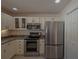 Bright kitchen, featuring stainless steel appliances and white cabinets at 17074 Se 75Th Wickson Ct, The Villages, FL 32162