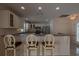 This kitchen features a breakfast bar and stainless steel appliances at 17074 Se 75Th Wickson Ct, The Villages, FL 32162