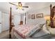 Charming bedroom with a post bed, ceiling fan, and plenty of natural light at 17470 Se 115Th Terrace Rd, Summerfield, FL 34491