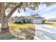 Gray house with white accents, two-car garage, and landscaped yard at 17470 Se 115Th Terrace Rd, Summerfield, FL 34491