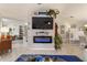 Living room featuring a modern electric fireplace and built-in shelving at 17470 Se 115Th Terrace Rd, Summerfield, FL 34491