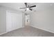 Bedroom with ceiling fan, grey carpet and double door closet at 17698 Sw 113Th Pl, Dunnellon, FL 34432