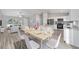 Kitchen and dining area with light wood table, white chairs, and hardwood floors at 17698 Sw 113Th Pl, Dunnellon, FL 34432