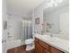 Clean bathroom with tub, toilet and wood vanity at 1817 Hallandale Ln, The Villages, FL 32162