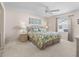 Bright bedroom with ceiling fan, large window, and wicker furniture at 1817 Hallandale Ln, The Villages, FL 32162