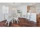 Bright dining area features a glass top table and white chairs at 1817 Hallandale Ln, The Villages, FL 32162