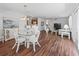 Open concept dining area with glass table and white wicker chairs at 1817 Hallandale Ln, The Villages, FL 32162