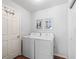 Bright laundry room with washer, dryer, and ample storage at 1817 Hallandale Ln, The Villages, FL 32162