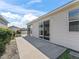 Concrete patio adjacent to the house at 1817 Hallandale Ln, The Villages, FL 32162