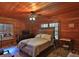 Cozy bedroom with wood walls, a ceiling fan, and plenty of natural light at 1838 Sw 97Th Pl, Ocala, FL 34476