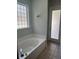 The bathroom features a soaking tub next to a glass block window and has tile floors at 1908 Sw 28Th St, Ocala, FL 34471