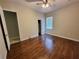 A comfortable bedroom with a ceiling fan, closet, window, and wood-look floors at 1908 Sw 28Th St, Ocala, FL 34471