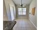 Cozy breakfast nook featuring tile flooring, a ceiling fan, and a bright window for natural light at 1908 Sw 28Th St, Ocala, FL 34471