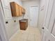 Laundry room with tile floors, cabinets, sink, and access to the exterior of the home at 1908 Sw 28Th St, Ocala, FL 34471