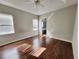 Main bedroom featuring wood-look floors, trey ceiling with fan, and a view into the main bathroom at 1908 Sw 28Th St, Ocala, FL 34471