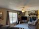 Spacious living room with stone fireplace and large windows at 200 Nw 53 Ct, Ocala, FL 34482