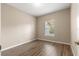 Simple bedroom with wood-look floors and large window at 231 Ne 28Th Ave # 301, Ocala, FL 34470