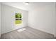 Well-lit bedroom with gray carpeting and a window at 24130 Nw Banyan Ln, Dunnellon, FL 34431