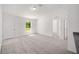 Bright and airy living room with gray carpet and front door entry at 24130 Nw Banyan Ln, Dunnellon, FL 34431