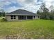 Exterior of home showcasing the backyard and roof at 35 Locust Radial Cir, Ocala, FL 34472