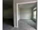 Bright bedroom featuring plush carpet and large window with ample natural light at 35 Locust Radial Cir, Ocala, FL 34472