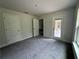Bedroom with gray carpet, doors to other rooms, and natural light at 35 Locust Radial Cir, Ocala, FL 34472