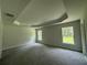 Spacious bedroom featuring gray carpet, natural light, and tray ceiling at 35 Locust Radial Cir, Ocala, FL 34472