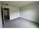Spacious bedroom featuring neutral walls and new gray carpeting and walk-in closet at 35 Locust Radial Cir, Ocala, FL 34472