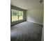 Bedroom with neutral gray carpet, natural light, and neutral paint at 35 Locust Radial Cir, Ocala, FL 34472