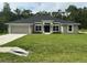 Charming single-story home featuring a well-manicured lawn and inviting curb appeal at 35 Locust Radial Cir, Ocala, FL 34472