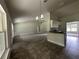 Spacious kitchen boasts granite countertops, an island with sink and a modern lighting fixture at 35 Locust Radial Cir, Ocala, FL 34472