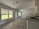 Well-lit kitchen area features granite countertops, an island sink and stainless faucet at 35 Locust Radial Cir, Ocala, FL 34472