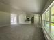 Bright open-concept living room featuring natural lighting, a breakfast bar, and neutral paint at 35 Locust Radial Cir, Ocala, FL 34472