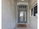 Inviting entryway with a grey door and tiled floor at 3708 Doune Way, Clermont, FL 34711