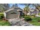 Single-story house with a landscaped yard, driveway, and American flag at 3708 Doune Way, Clermont, FL 34711