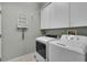 Laundry room with washer, dryer, and cabinets at 3708 Doune Way, Clermont, FL 34711