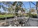 Screened porch with patio furniture and golf course view at 3708 Doune Way, Clermont, FL 34711