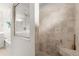 Walk-in shower with tiled walls and built-in seat at 5077 Sw 107Th Loop, Ocala, FL 34476