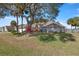 House exterior showcasing landscaping and large tree at 5459 Sw 84Th Ln, Ocala, FL 34476