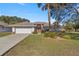 Single-story home with attached garage and manicured lawn at 5459 Sw 84Th Ln, Ocala, FL 34476