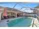 Screened-in pool with patio furniture and umbrellas at 5459 Sw 84Th Ln, Ocala, FL 34476