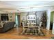 Bright dining area with a farmhouse table and black and white rug at 5991 Nw 61St Ct, Ocala, FL 34482