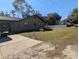 House with long driveway and mature trees at 5991 Nw 61St Ct, Ocala, FL 34482