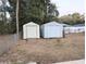 Two storage sheds in backyard, one off-white and one light blue at 5991 Nw 61St Ct, Ocala, FL 34482