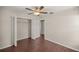 Bedroom with wood floors, double door closet, and ceiling fan at 6558 Se 9Th Pl, Ocala, FL 34472